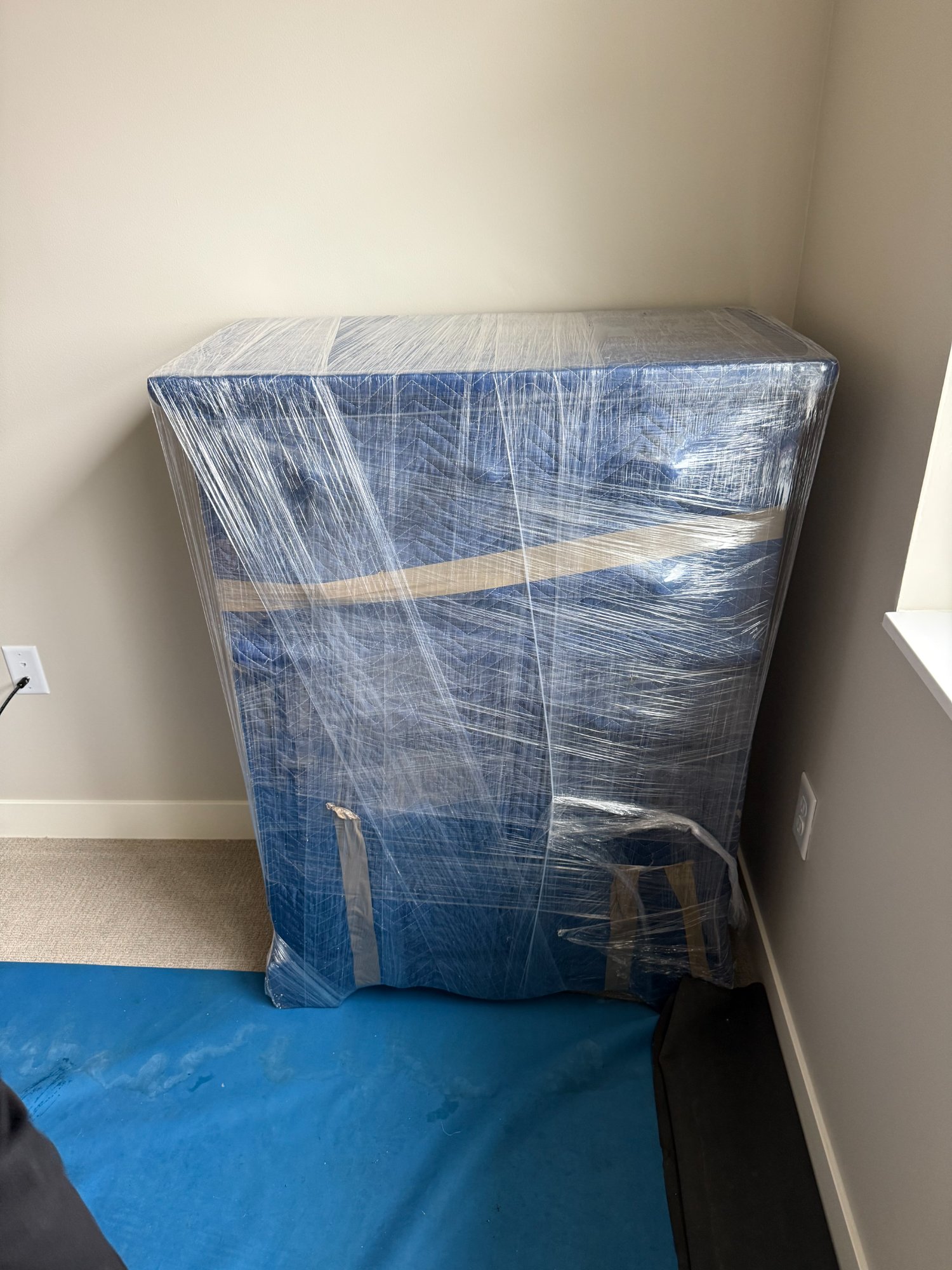 Dresser wrapped 360 degrees in moving pads and stretch film